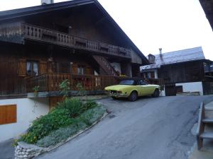 a yellow car parked in front of a building at Sweet Home in Cortina dʼAmpezzo