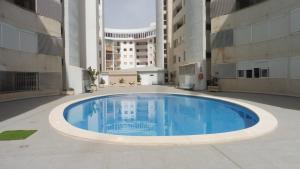 a large swimming pool in the middle of a building at Albamar in Calpe