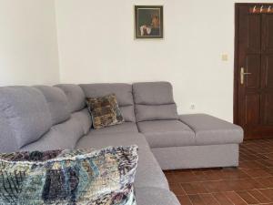 a gray couch in a living room with at Apartmani Novakovic in Petrovac na Moru