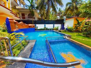 a swimming pool in a yard with a house at Casa Salvador in Calangute