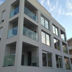a large white building with a large window at Apartments Exclusive Palace in Trogir