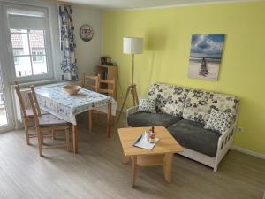 a living room with a couch and a table at Waldhaus Sellin in Ostseebad Sellin