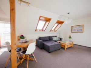 a living room with a couch and a table at Seaside 26 in Friedrichskoog