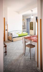 a room with two beds and a table and a bed at Residence Riviera in Palinuro