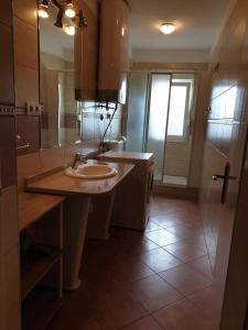 a bathroom with a sink and a large mirror at Apartment Kate in Omiš