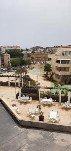 a patio with tables and white tables and chairs at Green Park in San Miguel de Abona +17 photos