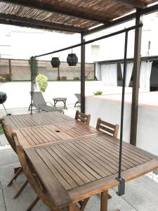 a wooden table and chairs on a patio at Casa ALBAYZÍN in Salobreña