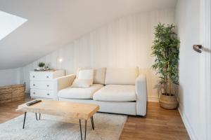 a living room with a white couch and a table at Txori-Toki in Zarautz