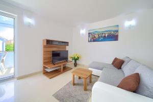 a living room with a couch and a tv at Apartment Anja in Krk