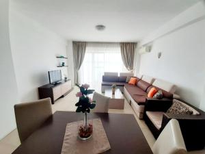 a living room with a couch and a table at Apartamente Sara Holiday in Mamaia