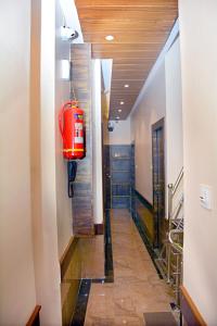 a hallway with a red suitcase in a building at Hotel Nest N Rest - Mumbai in Mumbai