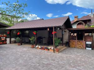 a pavilion with plants and flowers on a patio at Vila Andrei in Băile Olăneşti