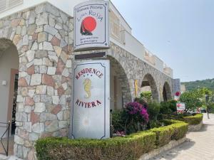 a building with two signs on the side of it at Residence Riviera in Palinuro