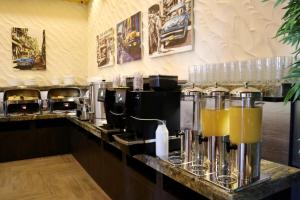 a kitchen with a counter with some drinks on it at VERTEX SPA hotel in Estosadok