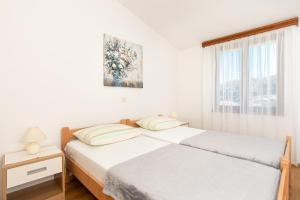 Un ou plusieurs lits dans un hébergement de l'établissement Apartments Dujmovic Ivo 1