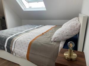 a bedroom with a bed with a wooden table at Duplex calme et cosy in Concarneau