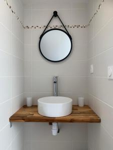 a white bathroom with a sink and a mirror at Duplex calme et cosy in Concarneau +10 photos