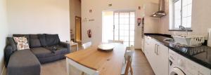 a kitchen and living room with a couch and a table at Houses of Eira Velha in Fajã do Ouvidor +17 photos