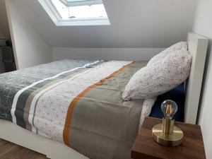 a bedroom with a bed with a wooden table at Duplex calme et cosy II in Concarneau