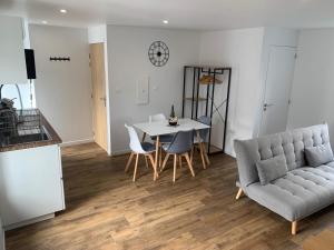 a living room with a table and a couch at Duplex calme et cosy II in Concarneau