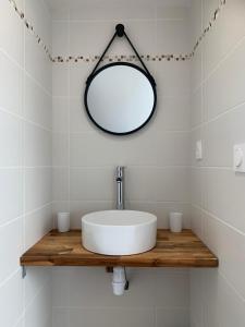 a bathroom with a sink and a mirror at Duplex calme et cosy II in Concarneau
