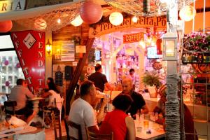 a group of people sitting at tables in a restaurant at Serena 2-8 in Lido di Pomposa