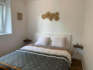 ein Schlafzimmer mit einem Bett mit zwei Kissen in der Unterkunft Appartement calme et chaleureux in Concarneau