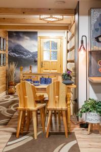 a dining room with a table and chairs at Harendzianka in Zakopane