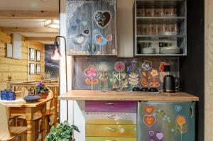 a kitchen with a cabinet with flowers on it at Harendzianka in Zakopane +26 photos