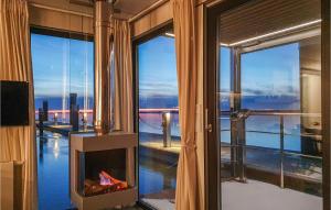 a room with a fireplace and a view of the water at Mermaid-hausboote 2 in Lelystad