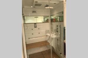 a bathroom with a shower with a glass door at Le jardin in Aix-en-Provence +23 photos