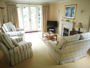 a living room with two chairs and a fireplace at The Old Bakery, Long Street in Enford