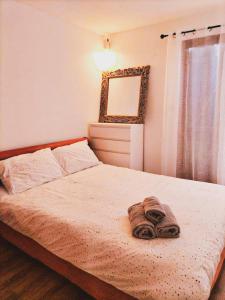 a bedroom with a bed with a towel on it at Magnifique Villa a Tourbes proche du Cap d Agde in Tourbes +26 photos
