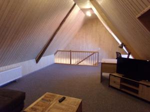 a living room with a staircase in a attic at Zehnthof in Geldersheim