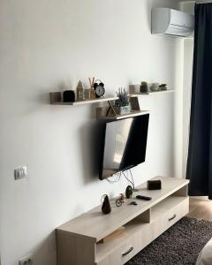 a living room with a tv on a white wall at Conest Vision Studio in Iaşi