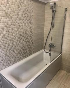 a white bath tub in a bathroom with a shower at Conest Vision Studio in Iaşi