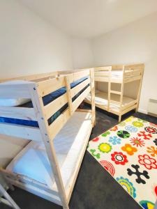 two bunk beds in a room with a rug at Cscape3 in Cowes
