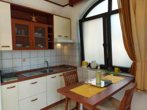 a kitchen with a table and a sink and a window at P&Z Apartments in Rab +94 photos
