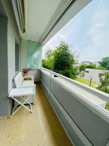 a balcony with a white chair and a large window at Fewo Dresden Zentrum Nähe Hauptbahnhof in Dresden