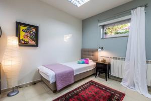 a bedroom with a bed and a window and a table at Villa Lidija in Poreč
