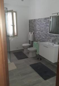 a bathroom with a toilet and a tub and a sink at Casa Dolce Casa in Reggio di Calabria