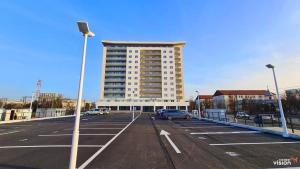 a parking lot with a large building in the background at Conest Vision Studio in Iaşi