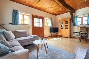 a living room with a couch and a table at Spieker in Hude