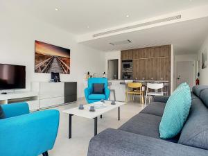 a living room with a blue couch and a table at Villa sol - Sucina - 3909 in Sucina