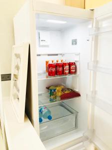 a refrigerator door open with food and drinks in it at PRECIOSO APARTAMENTO con PISCINA in Ruidera
