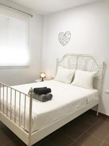 a bedroom with a white bed with a heart on the wall at PRECIOSO APARTAMENTO con PISCINA in Ruidera