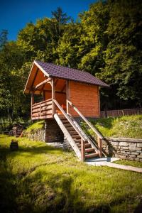 a small cabin with a staircase leading up to it at Марканна in Petrashani