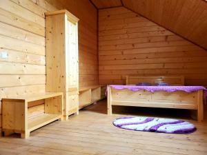 a room with a bed in a wooden cabin at Марканна in Petrashani +9 photos