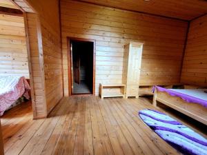 a room with two beds in a wooden cabin at Марканна in Petrashani