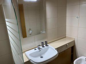 a bathroom with a sink and a mirror at LUNA - Airco - Sea view - First line - Own parking in Armação de Pêra